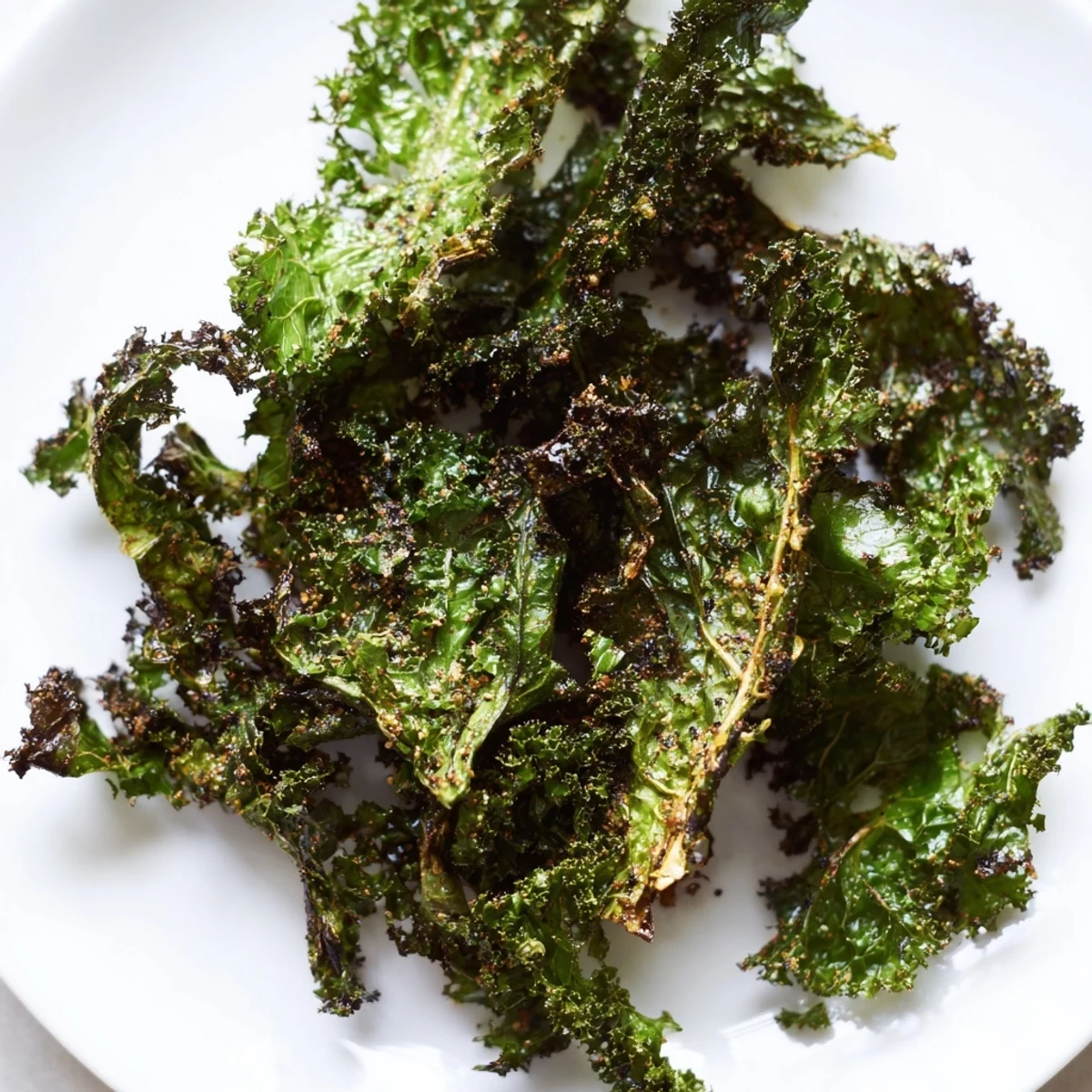 Golden, perfectly crisp oven-baked kale chips, a healthy and savory American snack idea.