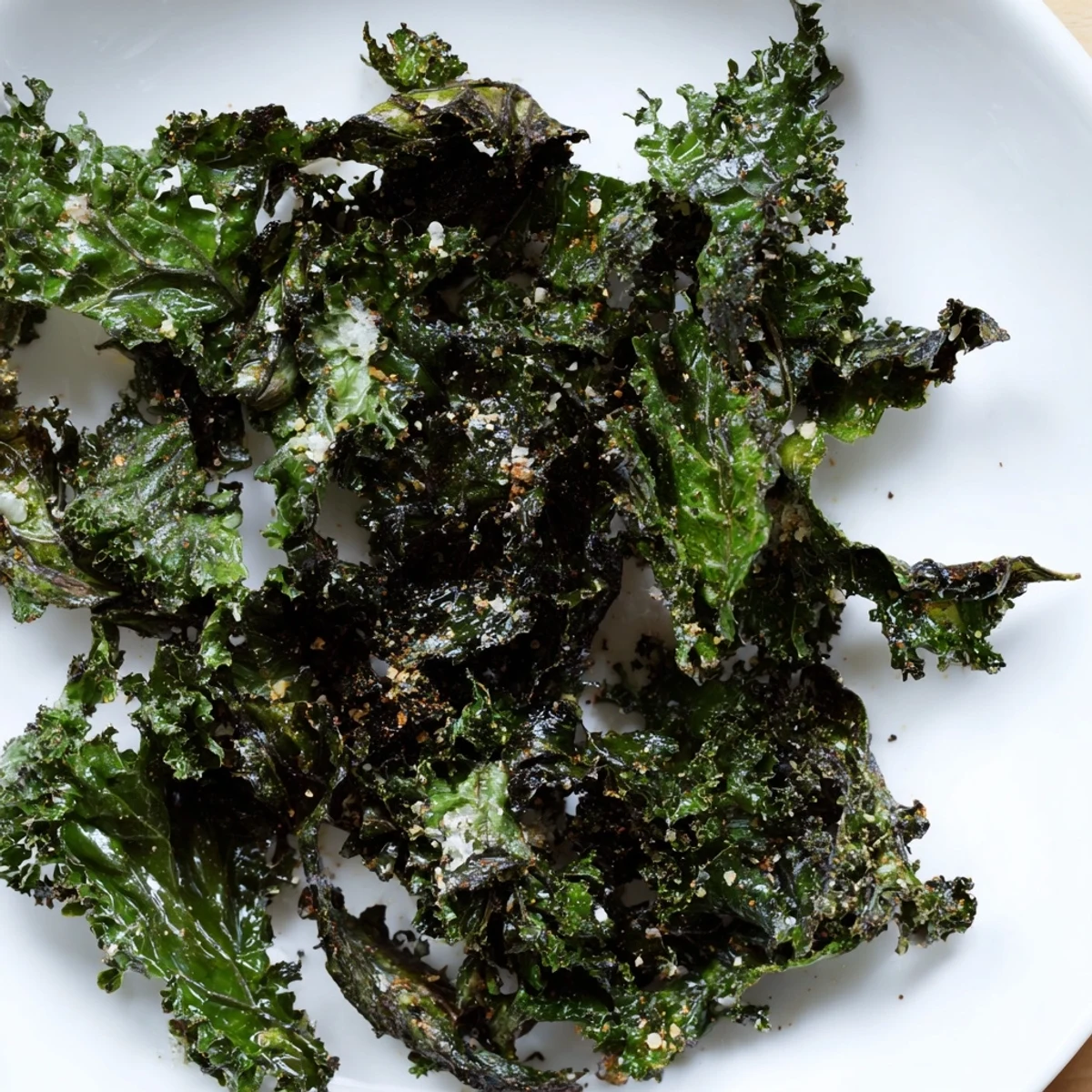 Crunchy texture of freshly baked kale chips, seasoned perfectly for a vegan, gluten-free treat.