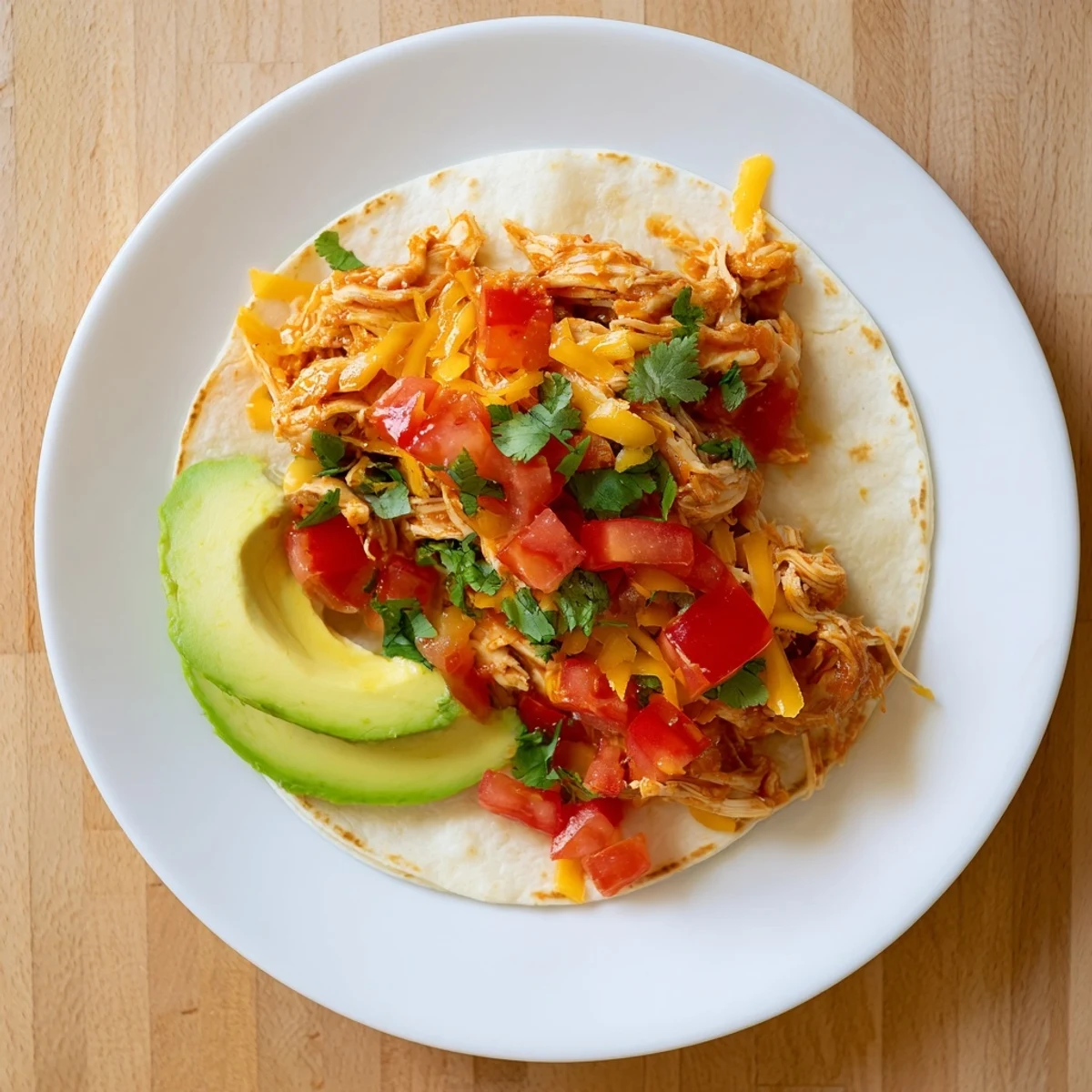Slow Cooker Shredded Chicken Tacos spilling out of warm tortillas, ready for fresh toppings.