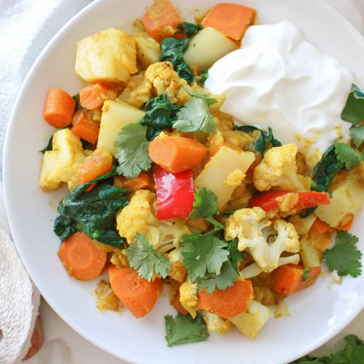 Steaming waste-free vegetarian curry with vibrant colors, served with fluffy rice and fresh cilantro.