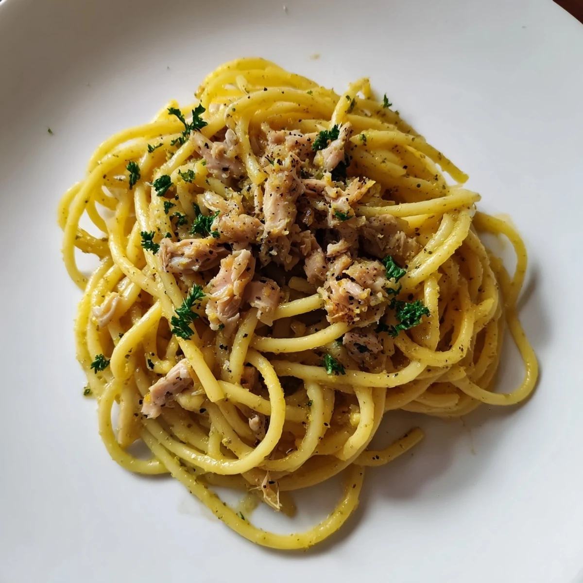 Close-up of Simple Garlic Butter Bucatini: pasta glistening in butter, topped with chicken, a perfect weeknight meal.