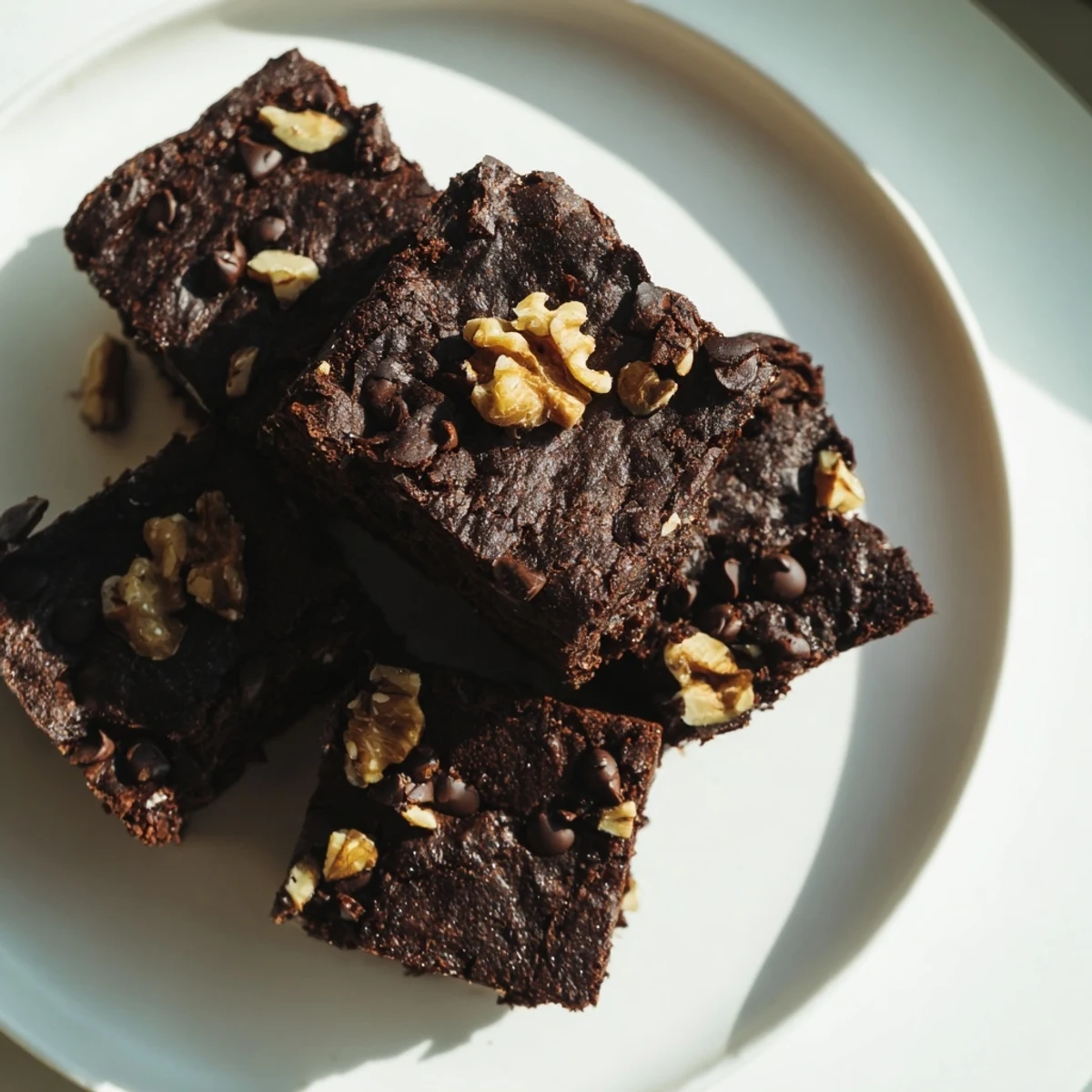 Warm, gooey Black Bean Brownies are studded with chocolate chips, ready to cut and serve.