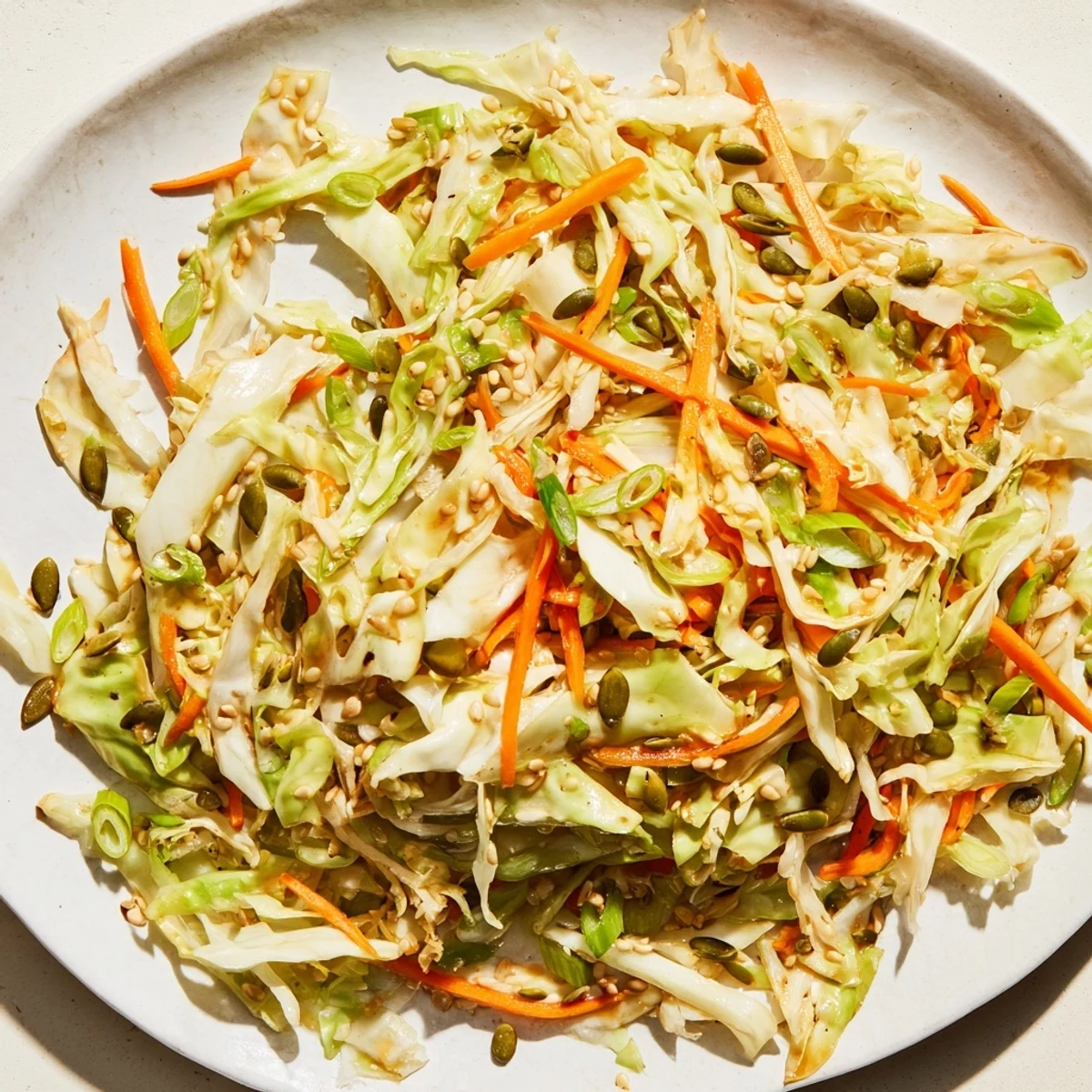 Delicious and crunchy Cabbage-Core Slaw Salad, featuring a sesame dressing, ready for a vegan meal.