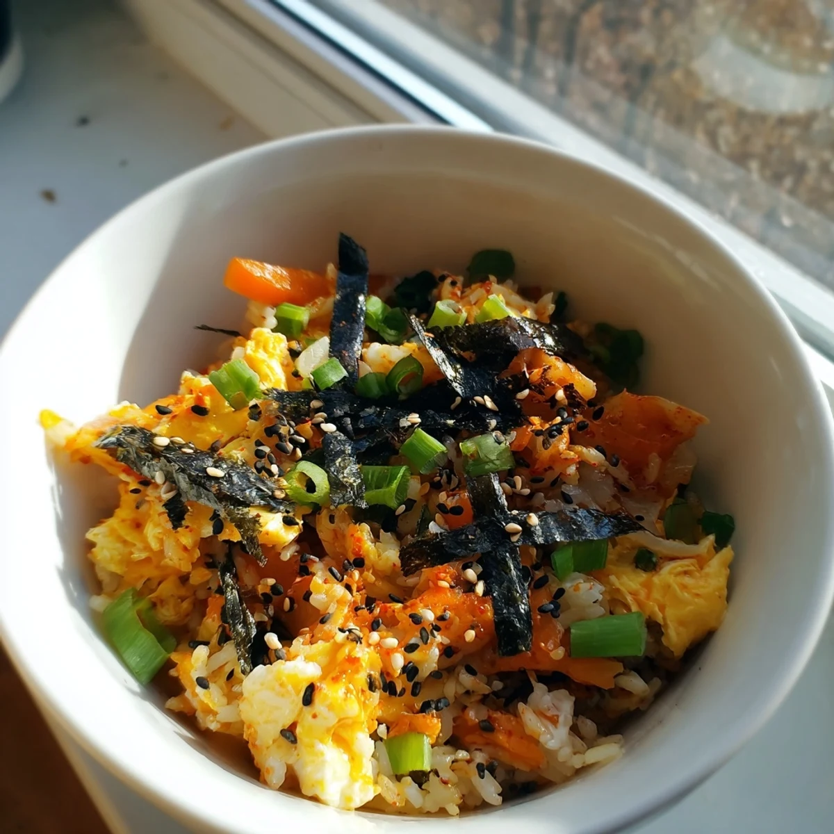 Hot Spicy Kimchi Fried Rice with a sunny-side-up egg, vibrant red kimchi, and scallions on a skillet.  