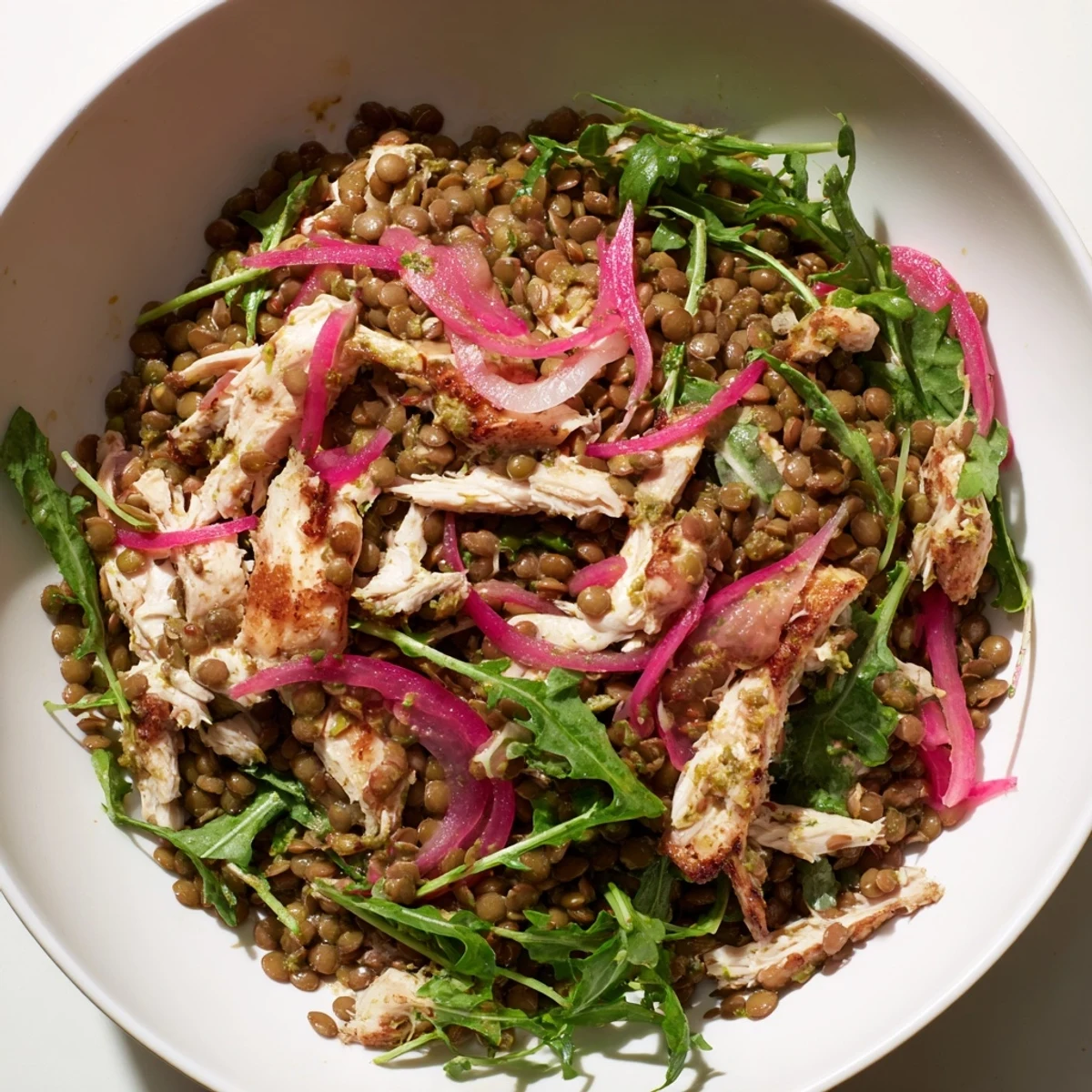 Lentil & Chicken Spring Salad served in a white bowl, featuring a zesty mustard dressing and fresh cherry tomatoes for a flavorful lunch.  