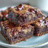 Fudgy Hojicha Brookies stacked high, featuring a deep brownie base and a crackly cookie top studded with chocolate chips.