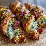 Fresh jalapeño slices and a bowl of spicy ranch dip sit beside the warm, freshly baked Jalapeño Popper Twists.