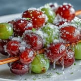 Frozen grape skewers with lime sugar offer a tangy, icy treat perfect for summer snacking or party platters.