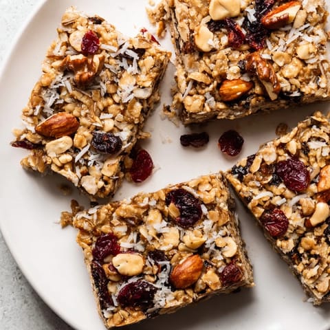 Golden-brown No-Bake Energy Bars, studded with nuts and dried fruit, ready for a healthy snack.