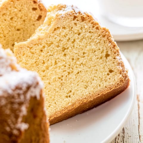 A freshly baked Simple 3-Ingredient Vanilla Sponge Cake, showing its light and airy texture.