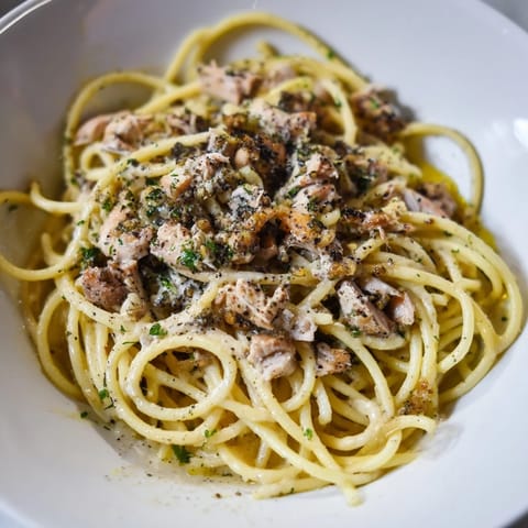 Golden Simple Garlic Butter Bucatini, tossed with flavorful garlic butter and shredded chicken, ready to eat.