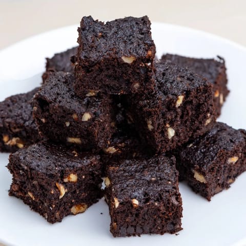 A close-up shot of rich, dark, flourless Black Bean Brownies, perfect for a gluten-free dessert.