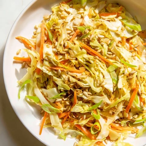 A close-up of a refreshing Cabbage-Core Slaw Salad, perfectly tossed and ready to eat.