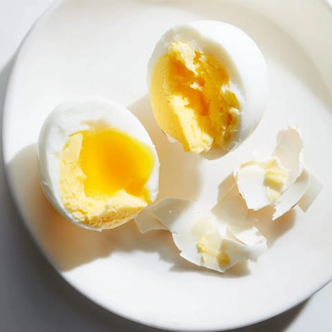 Perfect air fryer boiled eggs: bright yellow yolks and delicious whites, cooked to a perfect consistency, ready to eat.