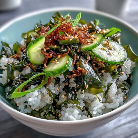 A colorful seaweed and nori rice bowl with seasoned sushi rice, crisp cucumber, and toasted sesame seeds for an umami-rich, refreshing meal.