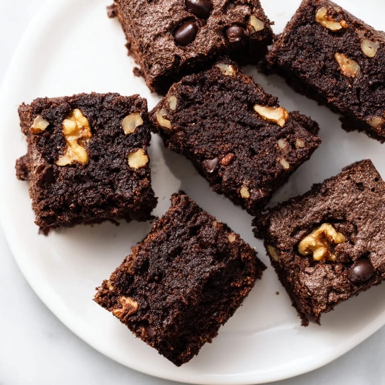 Fudgy squares of Black Bean Brownies, baked until set, with a sprinkle of chocolate on top.