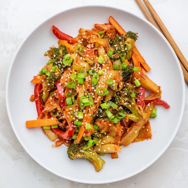 Hearty fermented veggie winter stir-fry served in a bowl, featuring sweet potato and cabbage with a tangy kimchi finish.  