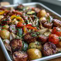 Fork-tender roasted vegetables and smoky sausage from this Smoky Sheet Pan Sausage & Veggies with Naan recipe, served hot.