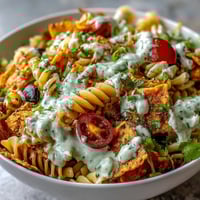 Vibrant Taco Pasta Salad with Doritos and Avocado Ranch dressing, loaded with colorful veggies and crunchy tortilla chips.  